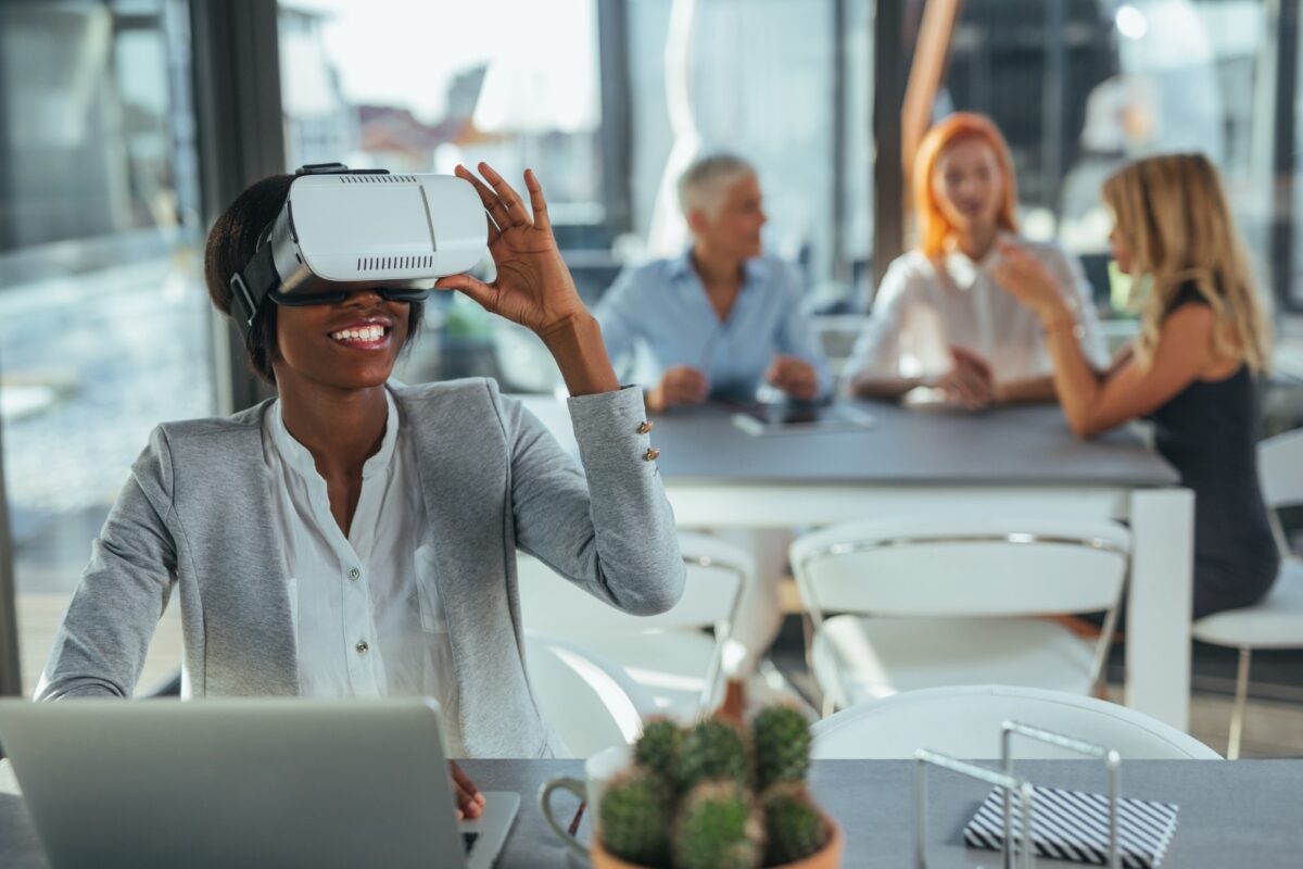 a smiling black woman using a virtual reality headset